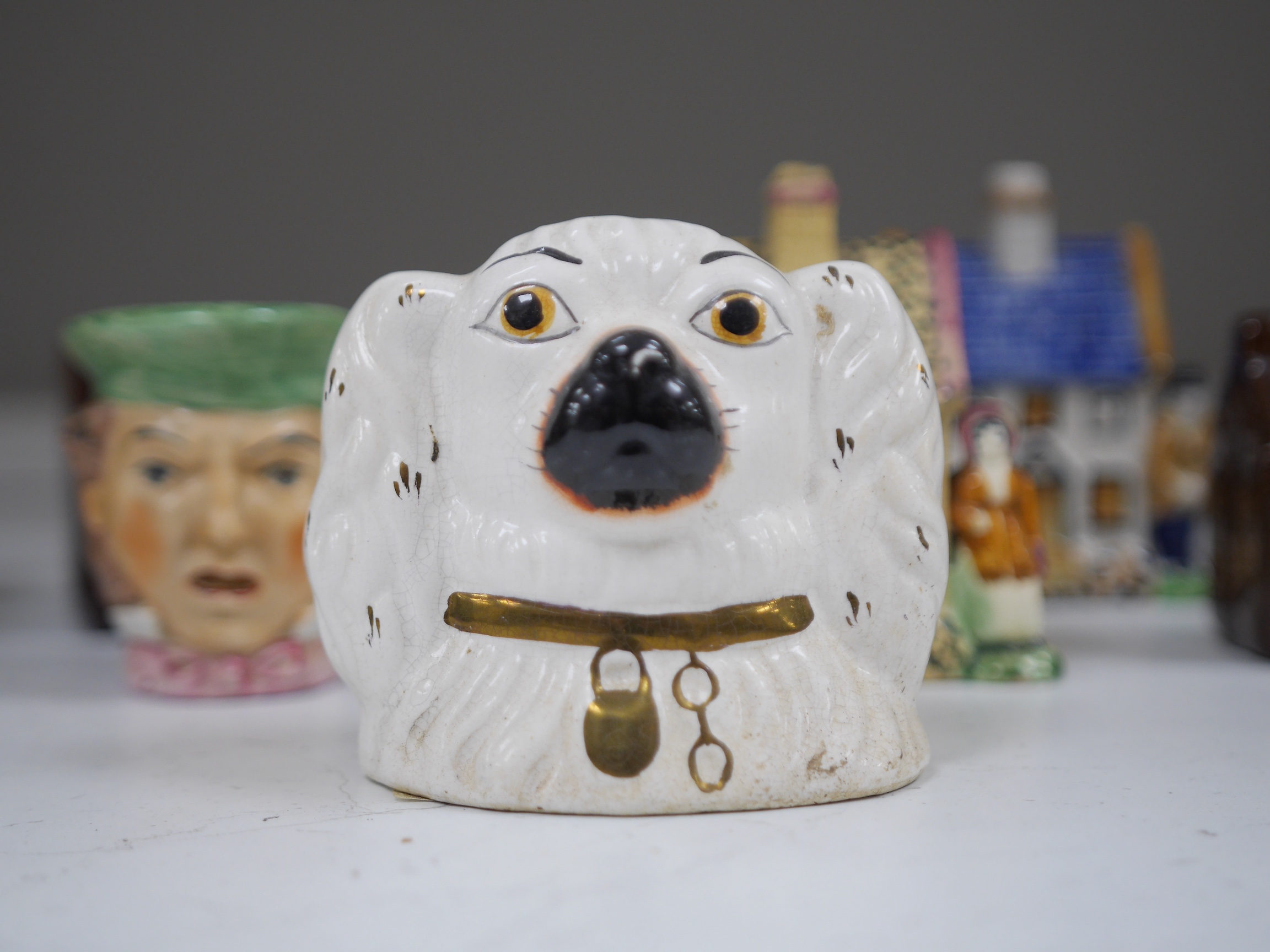 A group of ten novelty money boxes, including Staffordshire and glazed pottery money boxes, tallest 12.5cm high. Condition - two items chipped